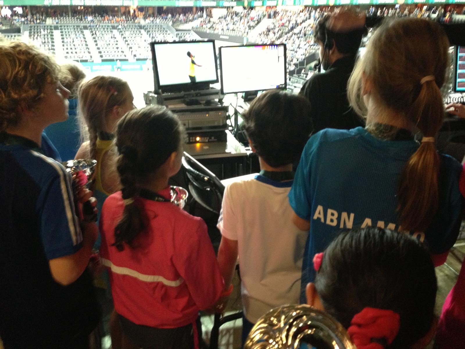 Academy players watching behind the scenes at the production and statistics desks of the ABN AMRO World Tennis Tournament