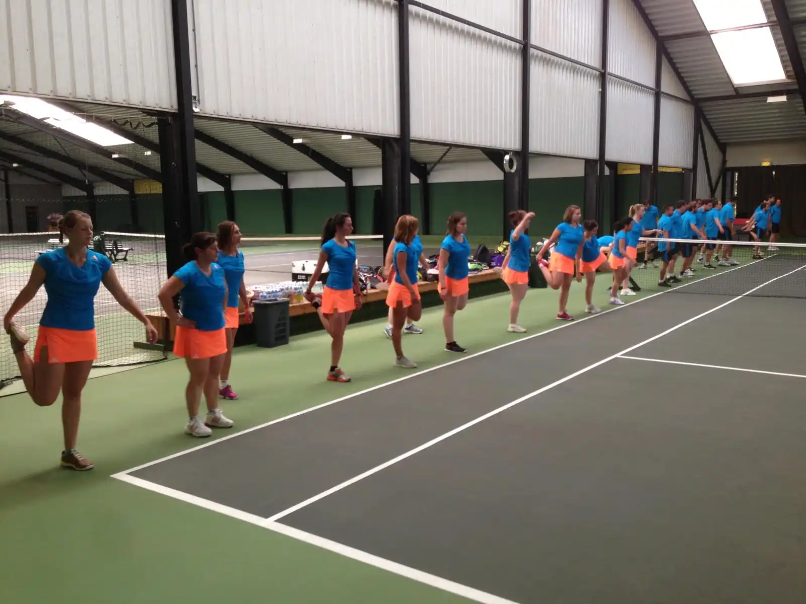adidas employees warming up during annual tennis clinic indoor
