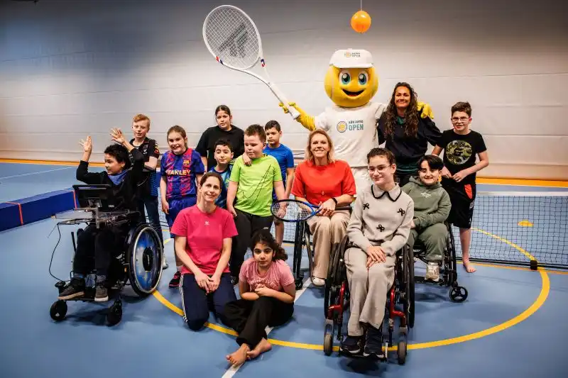 Group photo kids with mascot and coaches at inclusive clinic